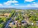 Aerial view showcasing the home's location in the neighborhood, outlined in red, with a large lake in the background at 1179 Seminole St, Clermont, FL 34711