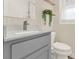 Bathroom featuring a gray vanity with quartz countertop and decorative tile flooring at 1179 Seminole St, Clermont, FL 34711