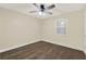 Cozy bedroom featuring hardwood floors and a large window at 1179 Seminole St, Clermont, FL 34711