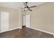 Bedroom with hardwood floors, neutral walls, ceiling fan, and white doors at 1179 Seminole St, Clermont, FL 34711