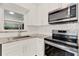 Updated kitchen featuring stainless steel appliances, white subway tile backsplash, and granite countertops at 1179 Seminole St, Clermont, FL 34711