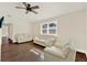 Spacious living room featuring hardwood floors, a ceiling fan, and ample seating at 1179 Seminole St, Clermont, FL 34711