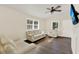 Bright living room with hardwood floors, a ceiling fan, and large windows at 1179 Seminole St, Clermont, FL 34711