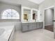 Bright bathroom featuring glass vessel sinks, modern vanity, and a separate tub and shower at 1213 Brampton Pl, Lake Mary, FL 32746