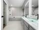 Bright bathroom featuring glass vessel sinks, modern vanity, and a separate tub and shower at 1213 Brampton Pl, Lake Mary, FL 32746