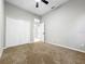 Neutral bedroom with a ceiling fan, carpeted floor, and a closet at 1213 Brampton Pl, Lake Mary, FL 32746