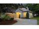 Charming single-story home with a well-manicured lawn, mature trees, and an inviting driveway at 1213 Brampton Pl, Lake Mary, FL 32746