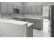 Modern kitchen with sleek gray cabinetry, stainless steel appliances, and quartz countertops at 1213 Brampton Pl, Lake Mary, FL 32746