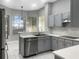 Well-lit kitchen with stainless steel appliances, gray cabinets, and quartz countertops at 1213 Brampton Pl, Lake Mary, FL 32746