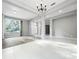 Bright living room featuring elegant chandelier and large windows offering lots of natural light at 1213 Brampton Pl, Lake Mary, FL 32746