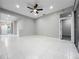 Spacious living area with neutral paint, white tiled floors and lots of natural light at 1213 Brampton Pl, Lake Mary, FL 32746