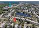 Aerial view showcasing the neighborhood with a pond, and proximity to Valencia College at 1232 Roma Ct, Orlando, FL 32825
