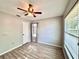 Bedroom features wood-look tile flooring, ceiling fan, mini blinds and a closet at 1232 Roma Ct, Orlando, FL 32825