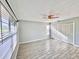 Bedroom features wood-look tile flooring, ceiling fan, closet, and mini blinds at 1232 Roma Ct, Orlando, FL 32825