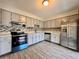 Well-equipped kitchen with stainless steel appliances, gray cabinets, and a stylish backsplash design at 1232 Roma Ct, Orlando, FL 32825