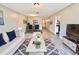 Stylishly decorated living room featuring wood-look floors, contemporary furnishings and a dining area beyond at 1232 Roma Ct, Orlando, FL 32825
