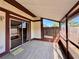 Screened in patio with wood-look tile flooring and sliding glass doors at 1232 Roma Ct, Orlando, FL 32825