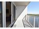 Balcony featuring a sliding glass door, tile floors, and a white metal safety railing at 13427 Blue Heron Beach Dr # 1802, Orlando, FL 32821