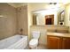 Well-maintained bathroom with bathtub, granite countertop vanity, and neutral tiling at 13427 Blue Heron Beach Dr # 1802, Orlando, FL 32821
