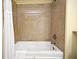 Tiled bathroom featuring a soaking tub with shower head and shower curtain at 13427 Blue Heron Beach Dr # 1802, Orlando, FL 32821