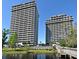 Waterfront condo buildings featuring numerous balconies with lake views in a lush surrounding at 13427 Blue Heron Beach Dr # 1802, Orlando, FL 32821