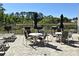 Outdoor community grilling area with seating near the lake and condominium units at 13427 Blue Heron Beach Dr # 1802, Orlando, FL 32821