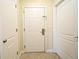 Bright hallway entrance featuring tile floors and a solid white door for a welcoming entry at 13427 Blue Heron Beach Dr # 1802, Orlando, FL 32821