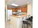 Eat-in kitchen with granite countertops, breakfast bar, and oak cabinets at 13427 Blue Heron Beach Dr # 1802, Orlando, FL 32821