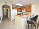 Eat-in kitchen with granite countertops, breakfast bar, and oak cabinets at 13427 Blue Heron Beach Dr # 1802, Orlando, FL 32821