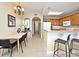 View of a kitchen and dining area with granite countertops, a breakfast bar, and a dining room table at 13427 Blue Heron Beach Dr # 1802, Orlando, FL 32821