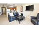 Living room features tile flooring, modern furnishings and an open view to the kitchen at 13427 Blue Heron Beach Dr # 1802, Orlando, FL 32821