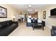 Open living room leading into dining and kitchen area is complete with tile floors at 13427 Blue Heron Beach Dr # 1802, Orlando, FL 32821