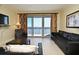 Comfortable living room with floor-to-ceiling windows and access to a balcony overlooking the water at 13427 Blue Heron Beach Dr # 1802, Orlando, FL 32821