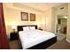 Comfortable bedroom featuring a king-size bed, soft lighting, closet and attached bathroom at 13427 Blue Heron Beach Dr # 1802, Orlando, FL 32821