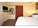 Cozy bedroom featuring a king-size bed, soft lighting, and TV for entertainment at 13427 Blue Heron Beach Dr # 1802, Orlando, FL 32821