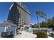 Large in ground community pool and condo building featuring multiple balconies at 13427 Blue Heron Beach Dr # 1802, Orlando, FL 32821