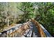 Community walking path with wood planks surrounded by trees at 13427 Blue Heron Beach Dr # 1802, Orlando, FL 32821