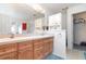 Bathroom features a double sink vanity, large mirror, and walk in closet at 14325 Golden View Dr, Grand Island, FL 32735