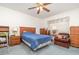 Bedroom with a ceiling fan, wooden furniture, and a window at 14325 Golden View Dr, Grand Island, FL 32735