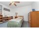 Bedroom with twin bed, dresser, bookshelf, and ceiling fan at 14325 Golden View Dr, Grand Island, FL 32735