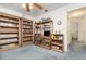 Bonus room with carpet flooring and wooden shelving units at 14325 Golden View Dr, Grand Island, FL 32735