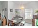Bright dining area with a chandelier, table with four chairs, and natural light from window at 14325 Golden View Dr, Grand Island, FL 32735