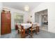 Carpeted dining room with a chandelier and view to kitchen area and large window at 14325 Golden View Dr, Grand Island, FL 32735