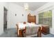 Dining room area with carpeted floor, table and chairs, large window, and overhead light fixture at 14325 Golden View Dr, Grand Island, FL 32735