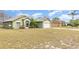 A pleasant green one-story home and lawn with a two-car garage in a suburban neighborhood at 14325 Golden View Dr, Grand Island, FL 32735