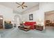 Spacious living area with a red sofa, wood furniture, and a ceiling fan at 14325 Golden View Dr, Grand Island, FL 32735