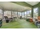Sunroom featuring multiple windows, ceiling fan, and ample space at 14325 Golden View Dr, Grand Island, FL 32735