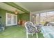 Bright sunroom with large windows, ceiling fan, and outdoor seating at 14325 Golden View Dr, Grand Island, FL 32735