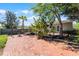 Spacious backyard with brick patio, lush greenery, and ample outdoor seating area at 1564 Cavendish Rd, Winter Park, FL 32789