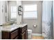 Bathroom featuring granite countertop vanity and decorative shower curtain at 1564 Cavendish Rd, Winter Park, FL 32789